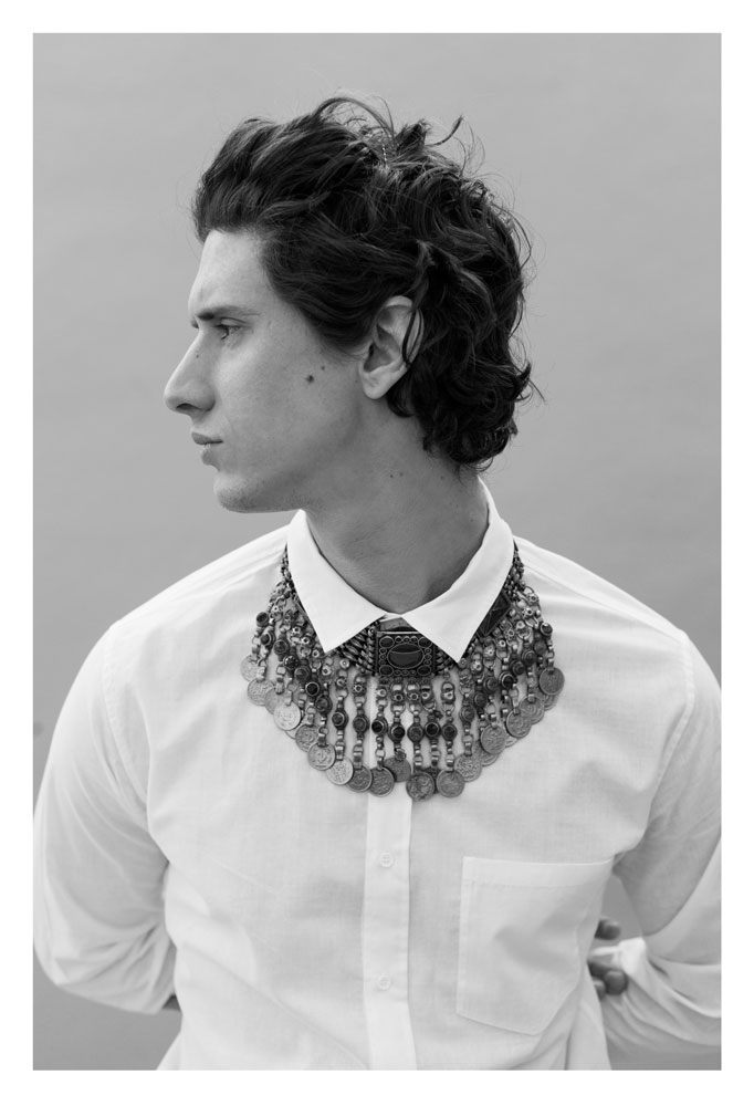 male model with white shirt and necklace by photographer geneviève schiurle on the man has style